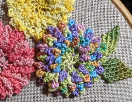 Donna is making chrysanthemums for her hat.Untitled