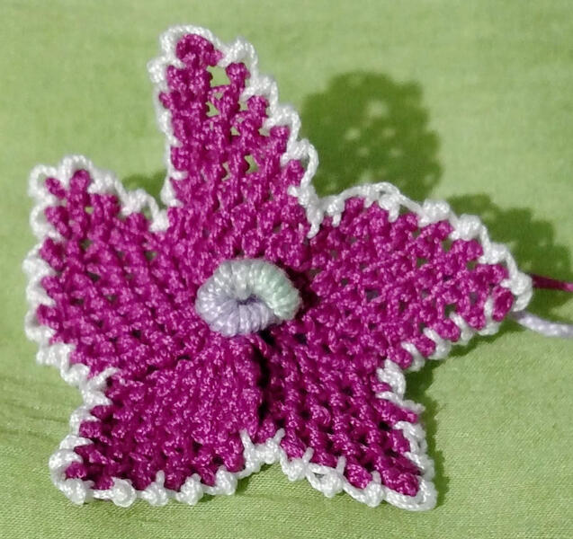 Joan's first flower using the raised center from the beginner's book, and the flower pattern from the quick guide. Dogwood Lace Guild, Springdale, AK.