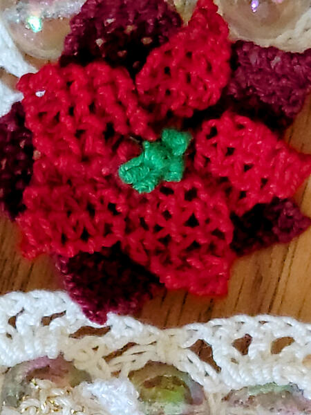 Sandra has is making a garland with poinsettias.